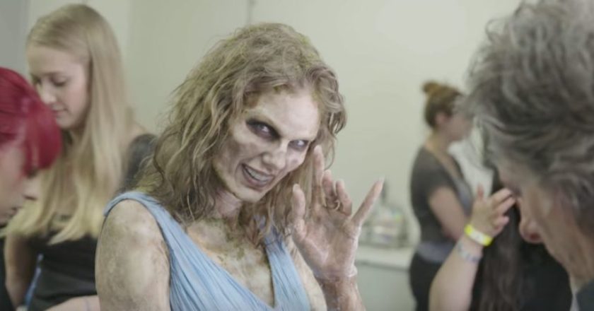 Taylor Swift in full zombie makeup eerily waving at the camera.