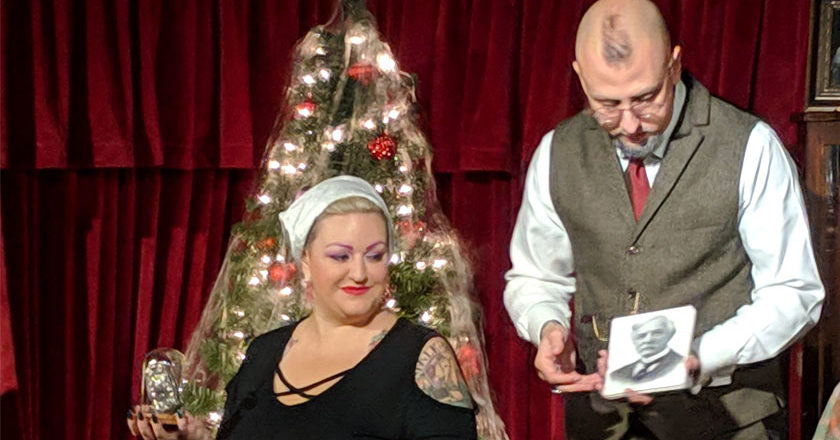 Aiden Sinclair with an audience volunteer during "Ghosts of Christmas Passed" at The Queen Mary