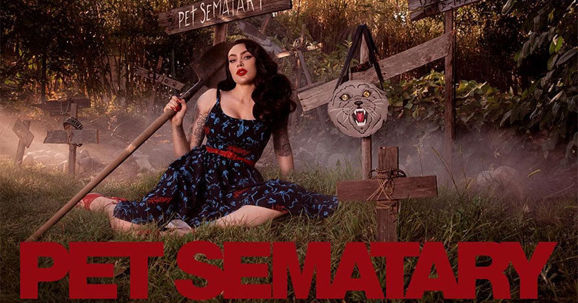 Micheline Pitt poses in one of her Pet Sematary dresses holding a shovel