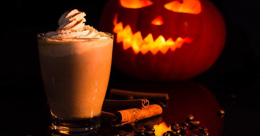 Pumpkin spice chocolate in front of a jack-o'-lantern.