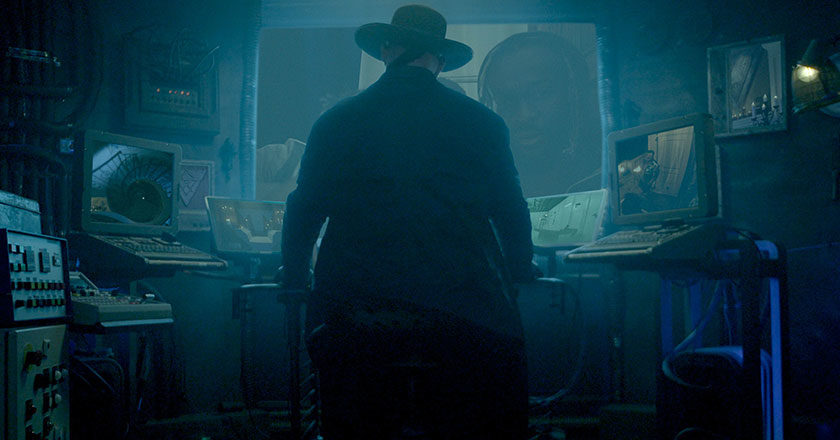 The Undertaker standing in front of a control center.