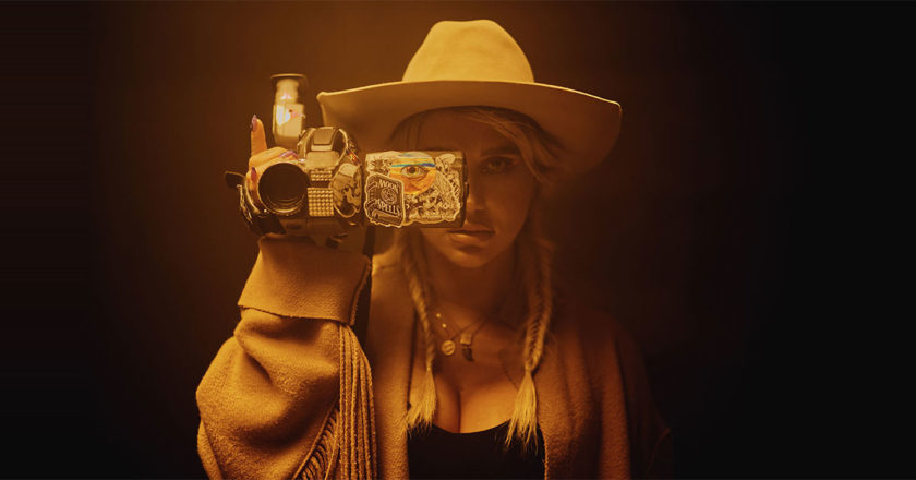 Kesha holding a camcorder