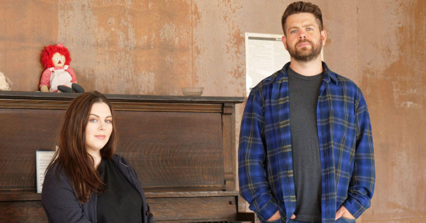 Katrina Weidman sits in front of a piano as Jack Osborne stands beside