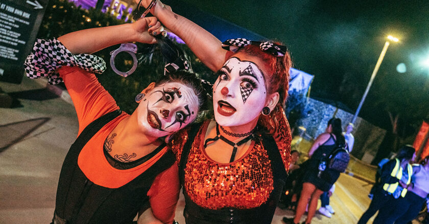 Two clowns strike a frightful pose at Howl-O-Scream